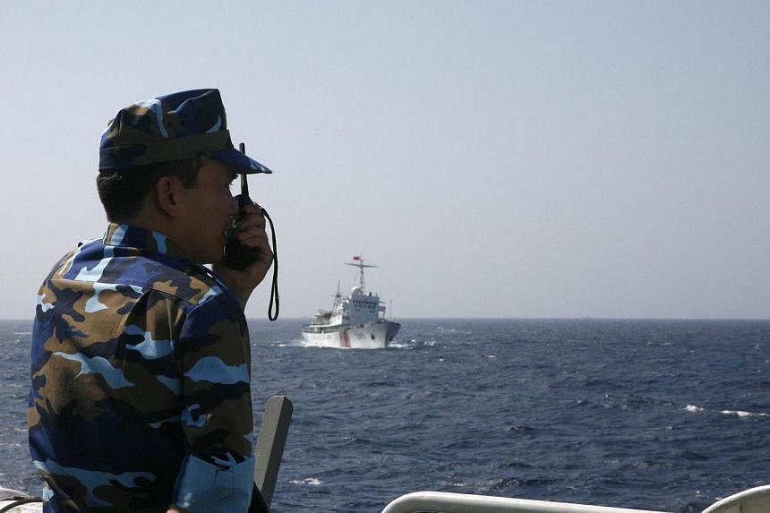 An officer of the Vietnamese marine guard monitoring a Chinese coast guard vessel in the South China Sea, about 210km off the coast of Vietnam. China is determined to uphold the country's controversial "nine-dashed line".
