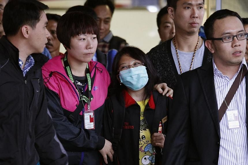 Ms Erwiana Sulistyaningsih (centre) being escorted out of the airport in Hong Kong in April, on her return to the city for a medical examination as part of the investigation into her case. -- PHOTO: REUTERS