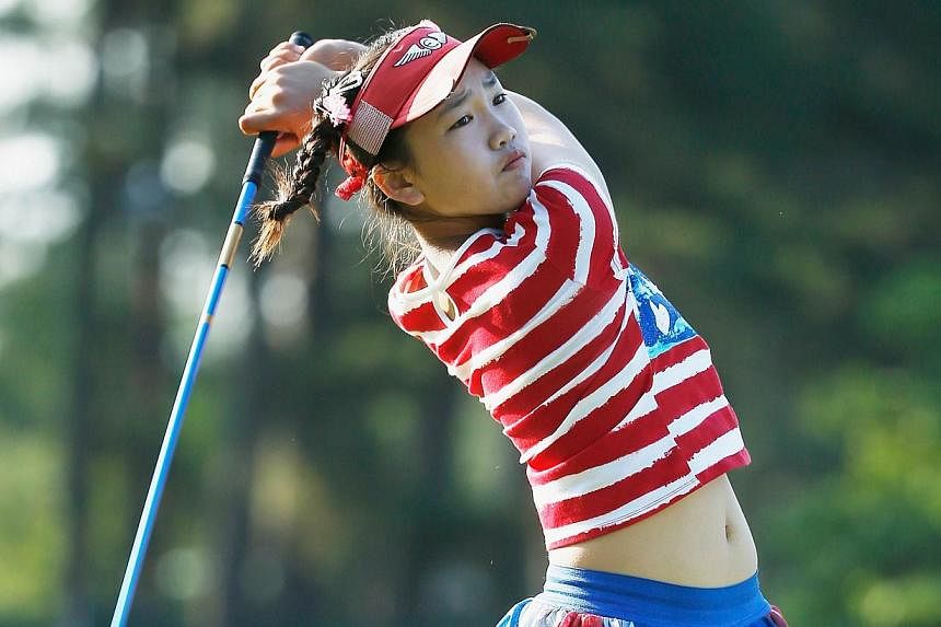 Eleven year-old Amateur Lucy Li of the United States hits her tee shot on the 13th hole during the first round of the 69th US Women's Open at Pinehurst Resort &amp; Country Club, Course No. 2 on June 19, 2014 in Pinehurst, North Carolina. -- PHOTO: A