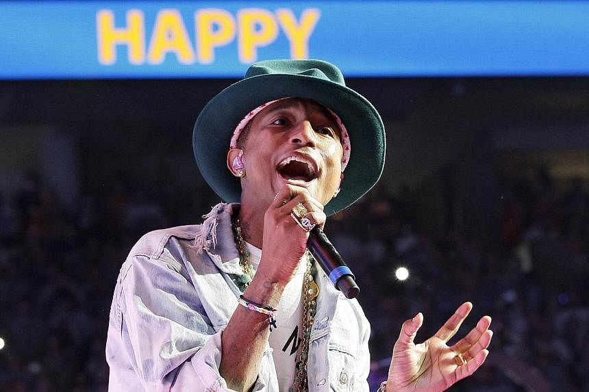 Singer Pharrell Williams performs his hit song Happy at the Walmart annual shareholders meeting in Fayetteville, Arkansas on June 6, 2014. -- PHOTO: REUTERS