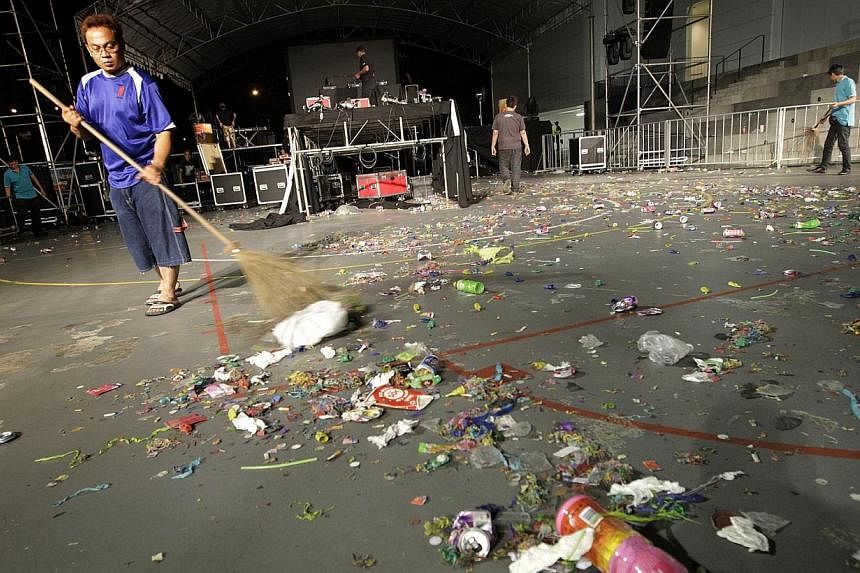 A janitor cleaning up litter after a New Year countdown party on Jan 1, 2011.&nbsp;While enforcement is still important to take litterbugs to task, there is also a need to "establish values and social norms" in public hygiene, said Second Minister fo