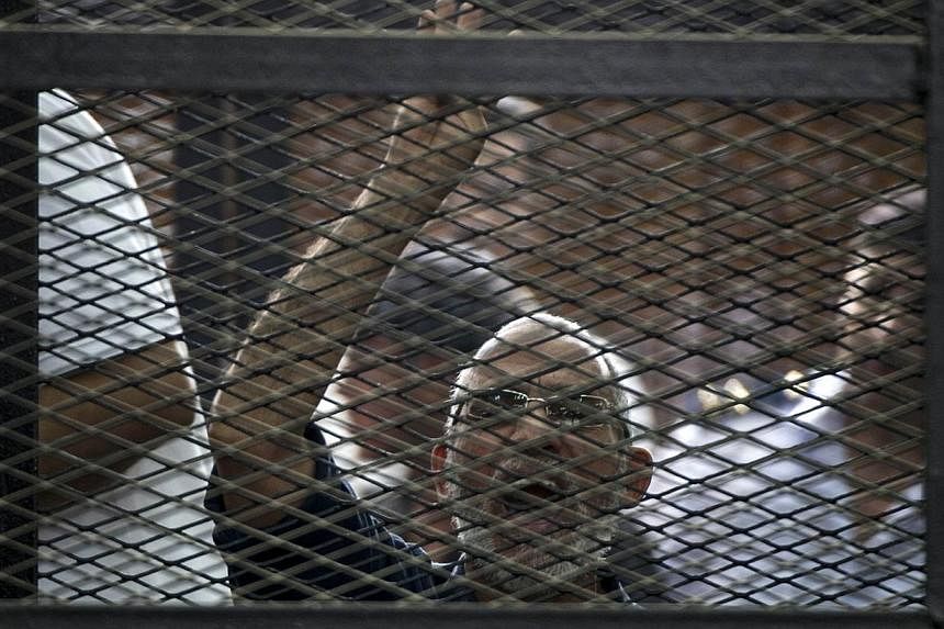 Egyptian Muslim Brotherhood leader Mohamed Badie gesturing as he shouts from inside the defendants cage during his trial in the capital Cairo on June 7, 2014.&nbsp;An Egyptian court on Saturday, June 21, 2014, confirmed death sentences for 183 Islami