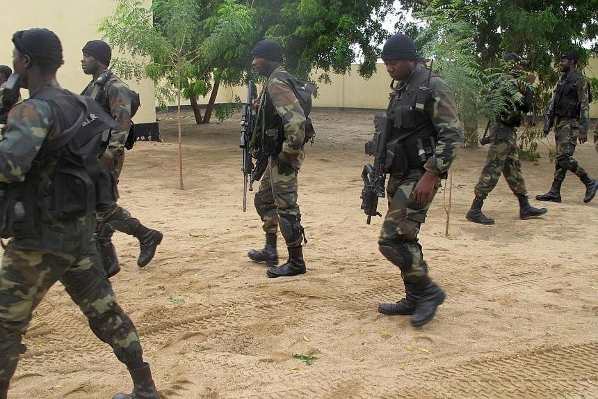 This photo taken on June 17, 2014 in the border town of Amchide, northern Cameroon, shows members of Cameroon's army elite force BIR (Brigade d'Intervantion Rapide, or Quick-Response Brigade), deployed as part of a reinforcement of its military actio