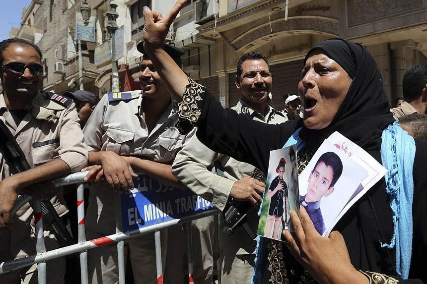 A woman reacts outside a court in Minya, south of Cairo, after the sentences of Muslim Brotherhood leader Mohamed Badie and his supporters were announced, on June 21, 2014. -- PHOTO: REUTERS