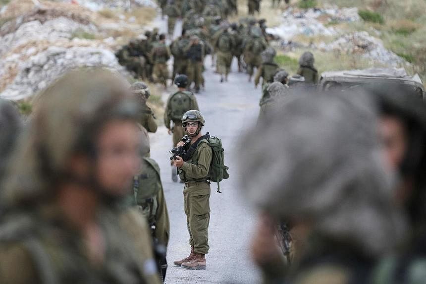 Israeli soldiers take part in an operation to locate three Israeli teens near the West Bank City of Hebron on June 21, 2014. -- PHOTO: REUTERS
