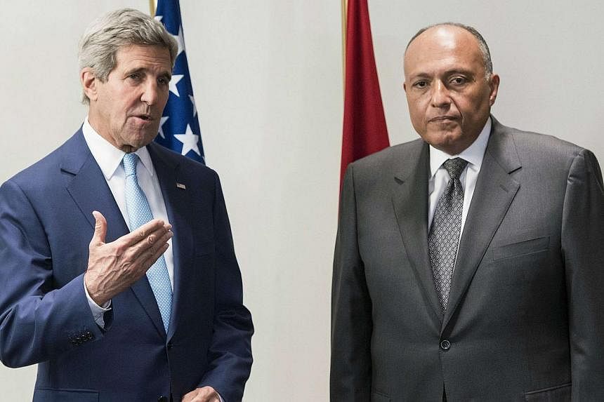 U.S. Secretary of State John Kerry (left) and Egyptian Foreign Minister Sameh Shoukri address the media before a meeting at a hotel in Cairo on June 22, 2014.&nbsp;US Secretary of State John Kerry on a surprise Egypt visit on Sunday urged Iraqi leade