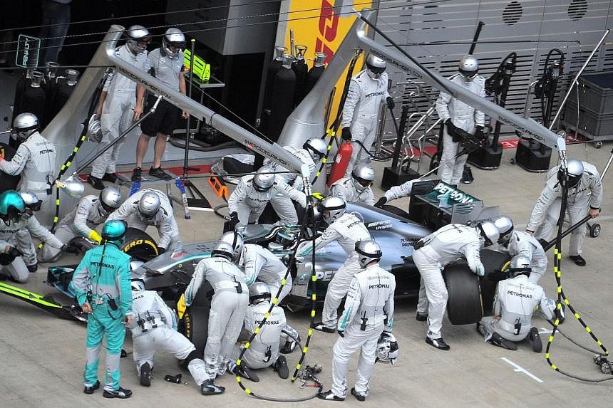 Mercedes' German driver Nico Rosberg makes a pit stop as he competes in the Austrian Formula One Grand Prix at the Red Bull Ring in Spielberg on June 22, 2014. -- PHOTO: AFP