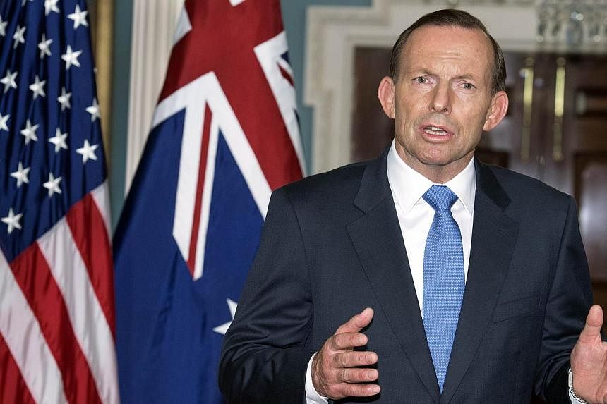 Australian Prime Minister Tony Abbott speaks during a photo opportunity on June 12, 2014. Australian Prime Minister Tony Abbott is "a sexist" rather than a misogynist, a retiring politician from his party said in an interview on Sunday. -- PHOTO: AFP