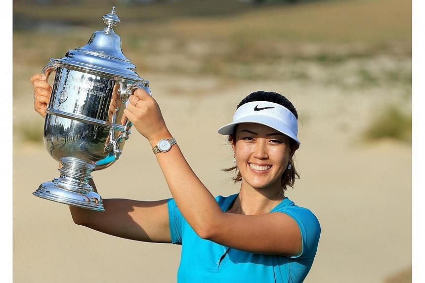 Michelle Wie of the USA proudly holds the trophy after her victory during the final round of the 69th US Women's Open at Pinehurst Resort &amp; Country Club, Course No 2, in Pinehurst, North Carolina on June 22, 2014. -- PHOTO: AFP