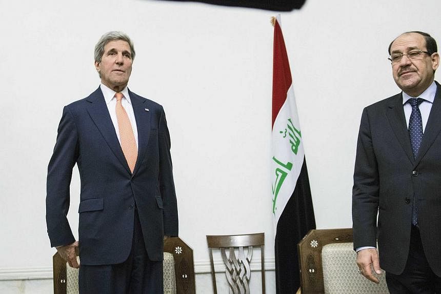 U.S. Secretary of State John Kerry (left) meets with Iraqi Prime Minister Nuri al-Maliki at the latter's office in Baghdad on June 23, 2014.&nbsp;US Secretary of State John Kerry was in Baghdad Monday to push for stability, as Sunni militants seized 