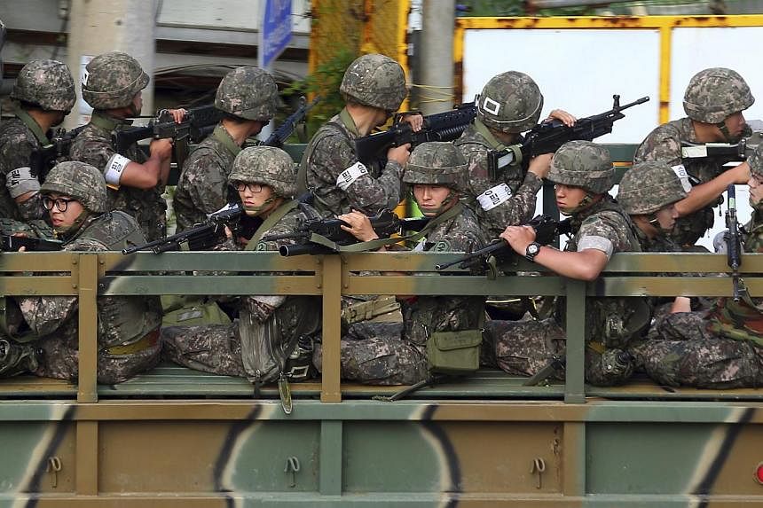 South Korean soldiers on a military vehicle take their position during a search and arrest operation in Goseong June 22, 2014. -- PHOTO: REUTERS