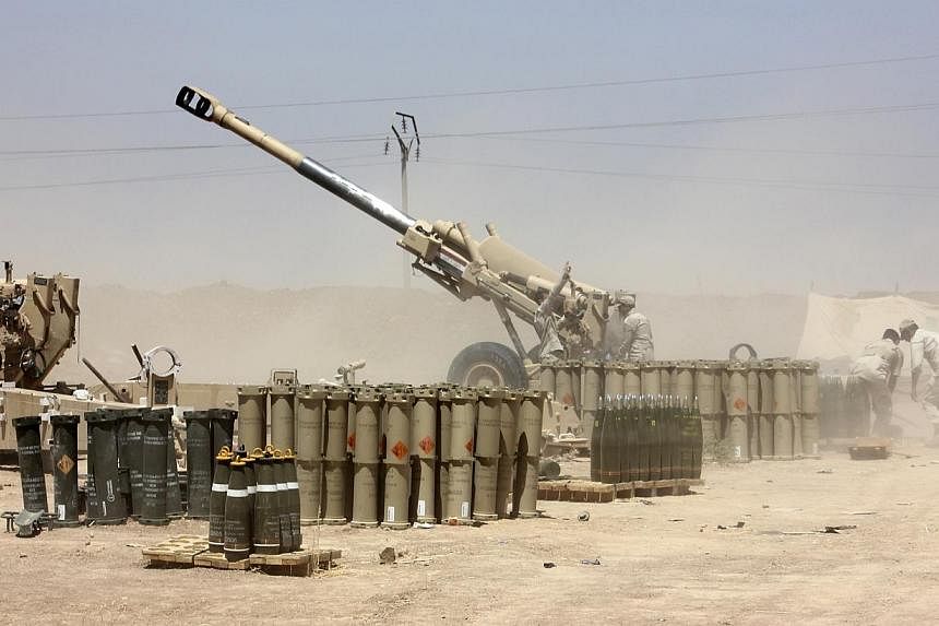 Iraqi security forces fire artillery during clashes with Sunni militant group Islamic State of Iraq and the Levant (ISIL) on the outskirts of the town of Udaim in Diyala province, on June 22, 2014. -- PHOTO: REUTERS