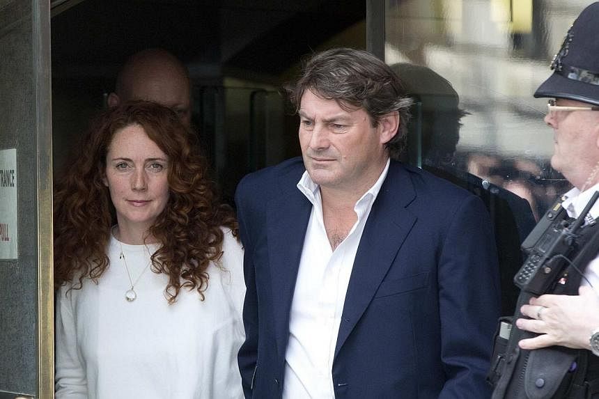 Former News International chief executive Rebekah Brooks (left) and her husband Charlie (right) leave the Old Bailey courthouse in London June 24, 2014.&nbsp;Former Rupert Murdoch confidante Rebekah Brooks was cleared of all charges while former News