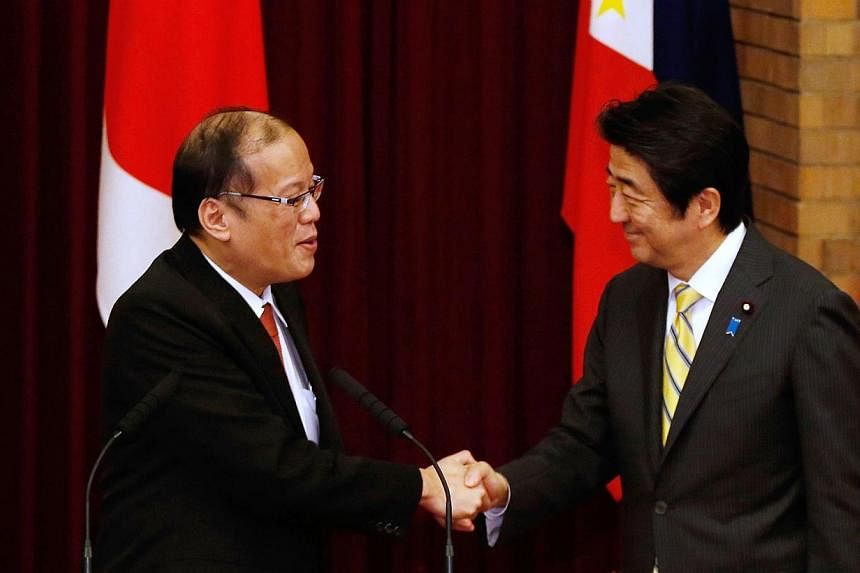 Philippines President Benigno Aquino (left) shakes hands with Japan's Prime Minister Shinzo Abe (right) during a joint news conference at the prime minister's official residence in Tokyo on June 24, 2014.&nbsp;Japan and the Philippines on Tuesday, Ju
