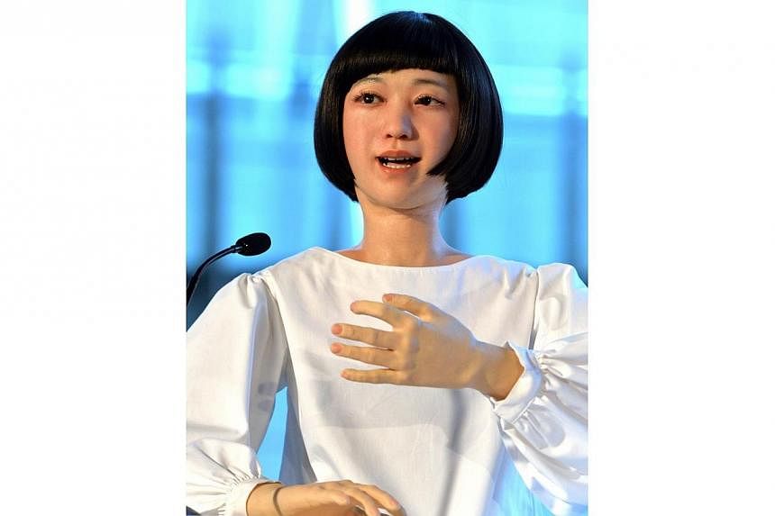 The new humanoid robot named "Kodomoroid" gestures at a press preview at the National Museum of Emerging Science and Technology in Tokyo on June 24, 2014. -- PHOTO: AFP