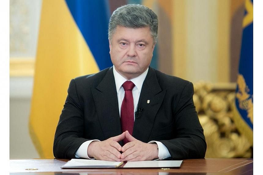 Handout picture taken and released by Ukrainian presidential press service on June 21, 2014 shows Ukrainian President Petro Poroshenko (centre) during his broadcast address to the nation.&nbsp;Ukrainian President Petro Poroshenko said on Tuesday, Jun