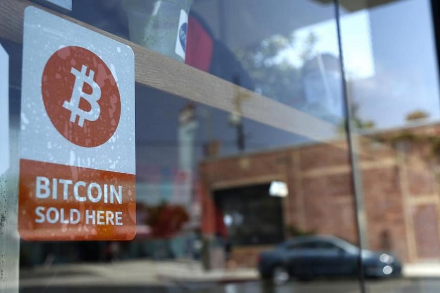 A bitcoin sticker in the window of a convenience store in Los Angeles, California. A new Bill passed by lawmakers&nbsp;would repeal what backers say is an outdated law prohibiting commerce using anything but US currency. PHOTO: REUTERS