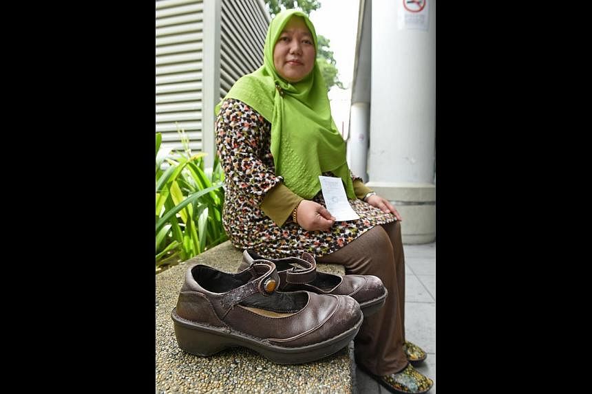 Ms Nur Najwa Abdullah and the $279 pair of shoes she bought last year. She said she wore them for six months before finding out – by chance – that the lining was made of pig skin. -- ST PHOTO: SEAH KWANG PENG