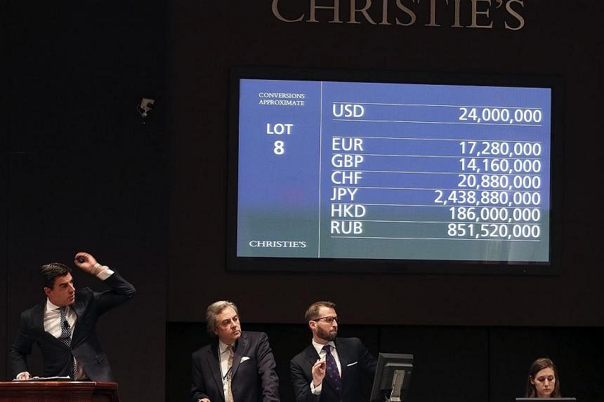 A Christie's moderator facilitates the sale of an artwork titled "Nympheas" by artist Claude Monet during a Christie's auction in New York May 6, 2014.&nbsp;An iconic Water Lilies painting by French artist Claude Monet sold for £31.7 million (S$67 m