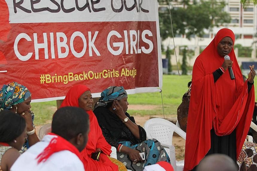 A member of the #BringBackOurGirls Abuja campaign group addresses a sit-in protest at the Unity Fountain in Abuja on June 18, 2014.&nbsp;Suspected Boko Haram militants have abducted more than 60 women and girls, some as young as three, in the latest 