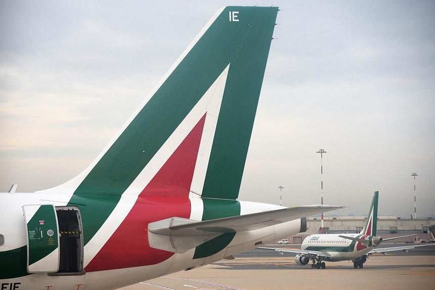 Abu Dhabi's state-owned Etihad Airways said on Wednesday, June 25, 2014, it had agreed principal terms and conditions to buy a 49 per cent stake in Italy's loss-making airline Alitalia. -- PHOTO: AFP