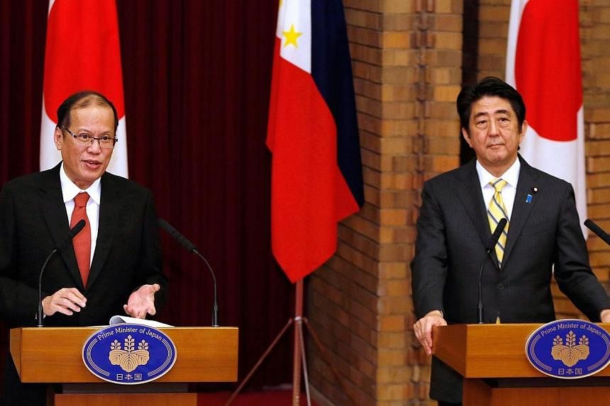 Philippines President Benigno Aquino (left) speaks as Japan's Prime Minister Shinzo Abe (right) listens during a joint news conference at the prime minister's official residence in Tokyo on June 24, 2014.&nbsp;China on Wednesday, June 25, 2014, accus
