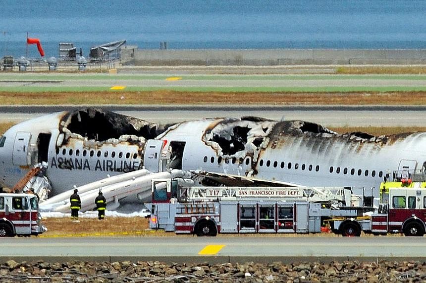 An Asiana Airlines Boeing 777 is seen on the runway at San Francisco International Airport after crash landing on July 6, 2013. -- PHOTO: AFP