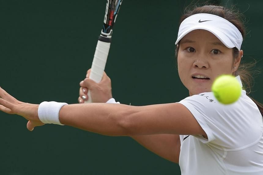 China's Li Na returns against Austria's Yvonne Meusburger during their women's singles second round match on day three of the 2014 Wimbledon Championships at The All England Tennis Club in Wimbledon, south-west London, on June 25, 2014. Li and five-t