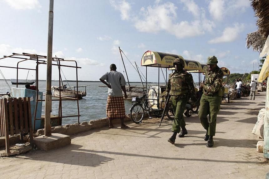Kenya police officers patrol along the beaches of the Indian Ocean in the coastal town of Lamu, June 19, 2014.&nbsp;Kenyan police have arrested the governor of the coastal Lamu district in connection with three recent massacres in which over 60 peopl