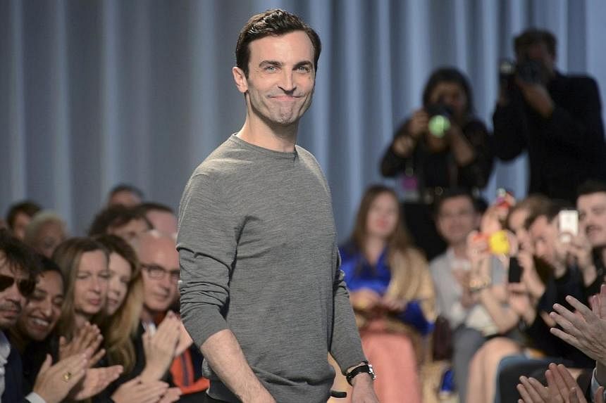French designer Nicolas Ghesquiere appears at the end of the Louis Vuitton fashion show in Monaco, on May 17, 2014. Ghesquiere and the company that chose him at the age of 26 to inherit the Balenciaga throne will face each other across a Paris courtr