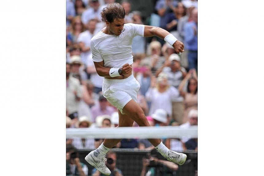 Spain's Rafael Nadal jumps and punches the air as he celebrates beating Czech Republic's Lukas Rosol during their men's singles second round match on day four of the 2014 Wimbledon Championships at The All England Tennis Club in Wimbledon, southwest 