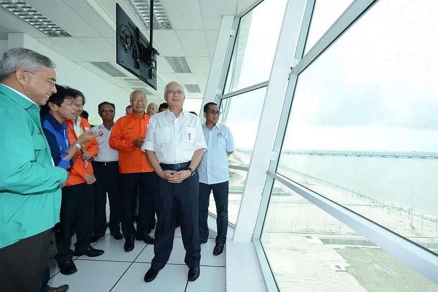 Malaysian prime minister Najib Razak looked out at the newly completed, 3km-long jetty for Pengerang Independent Terminals, an independent oil storage terminal built on 150 acres of reclaimed sea-bed land at the southern tip of Johor near Desaru. -- 