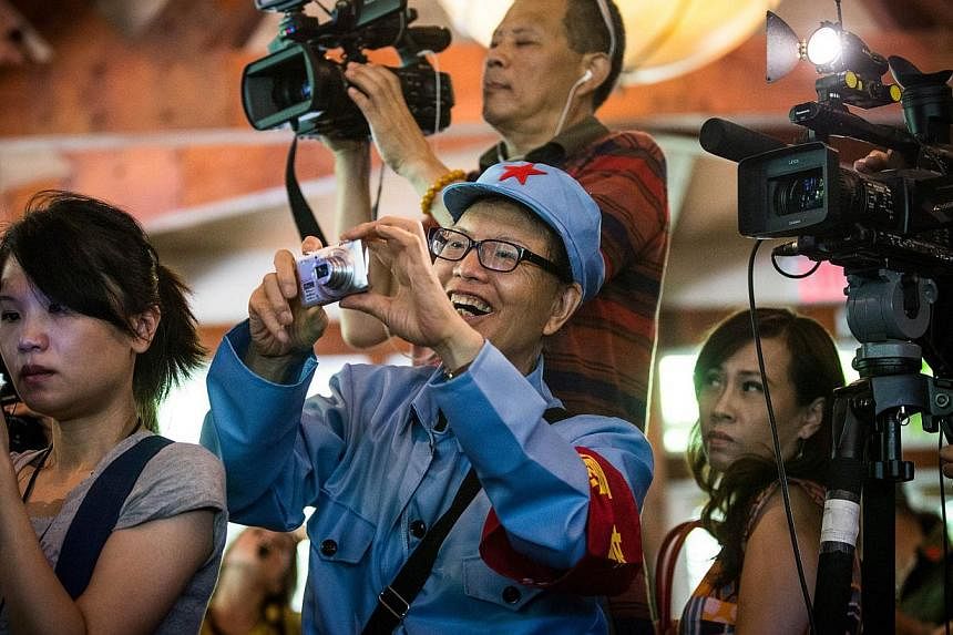Members of the media and fans attend a lunch and press conference held by Chen Guangbiao, a Chinese recycling magnate, who hosted to event as a lunch for approximately 200 homeless people, at The BoatHouse in Central Park, on June 25, 2014 in New Yor