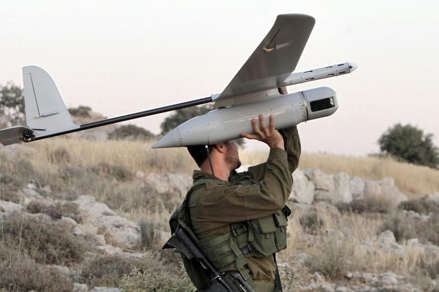 A drone being prepared by Israeli soldiers for use over the West Bank town of Hebron to search for three teenagers kidnapped earlier this month. Former&nbsp;top US officials, in a report, have acknowledged that the robotic aircraft are a useful tool 