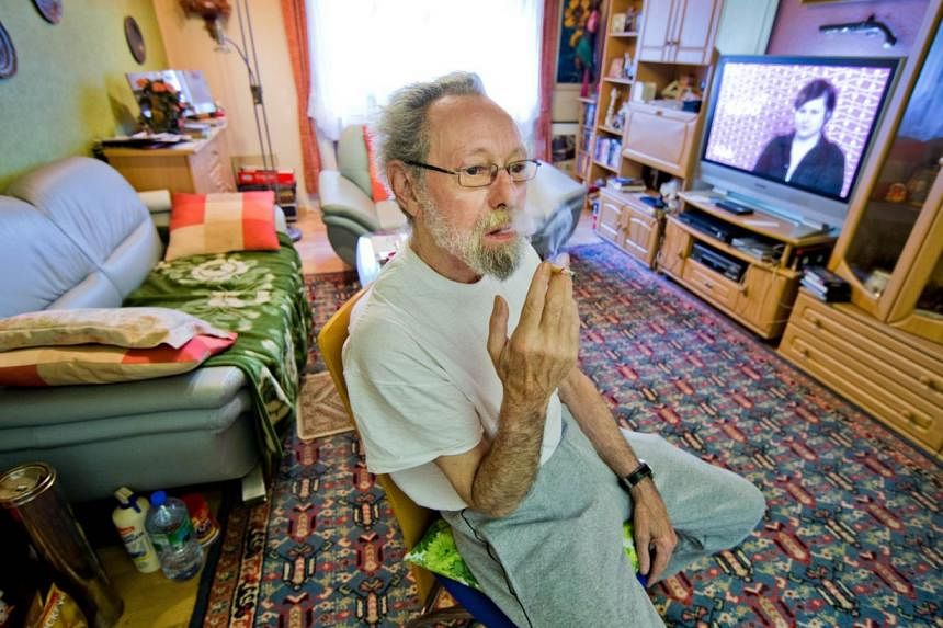 A photo from last year shows German Friedhelm Adolfs, 75, smoking in the living room of his flat in Duesseldorf, northwestern Germany. A German court ruled on June 26, 2014 that Adolfs must vacate his home of around 40 years after neighbours complain