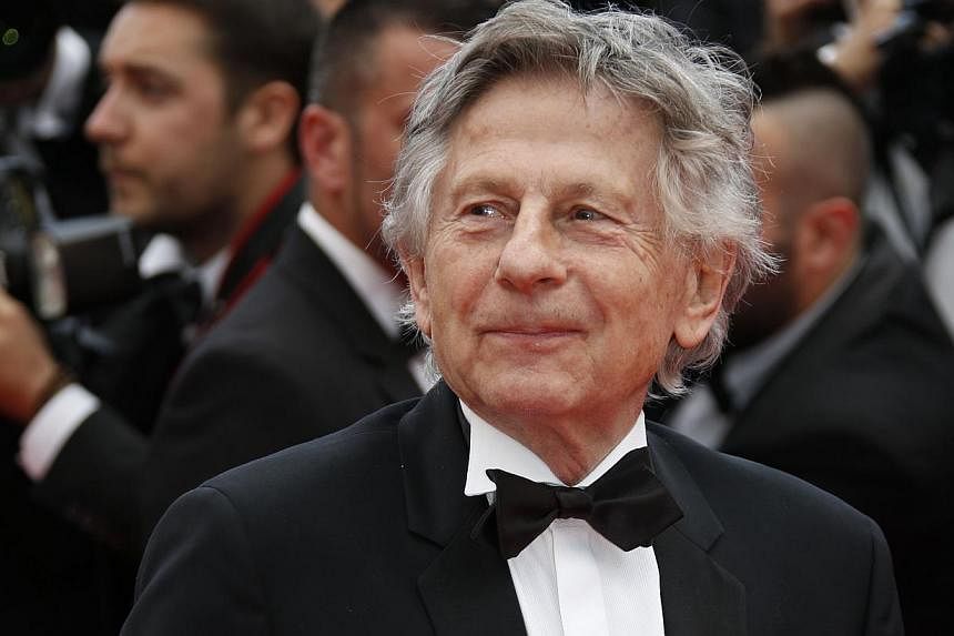 French director Roman Polanski poses as he arrives for the screening of the film Saint-Laurent at the 67th edition of the Cannes Film Festival in Cannes, southern France, on May 17, 2014. -- PHOTO: AFP