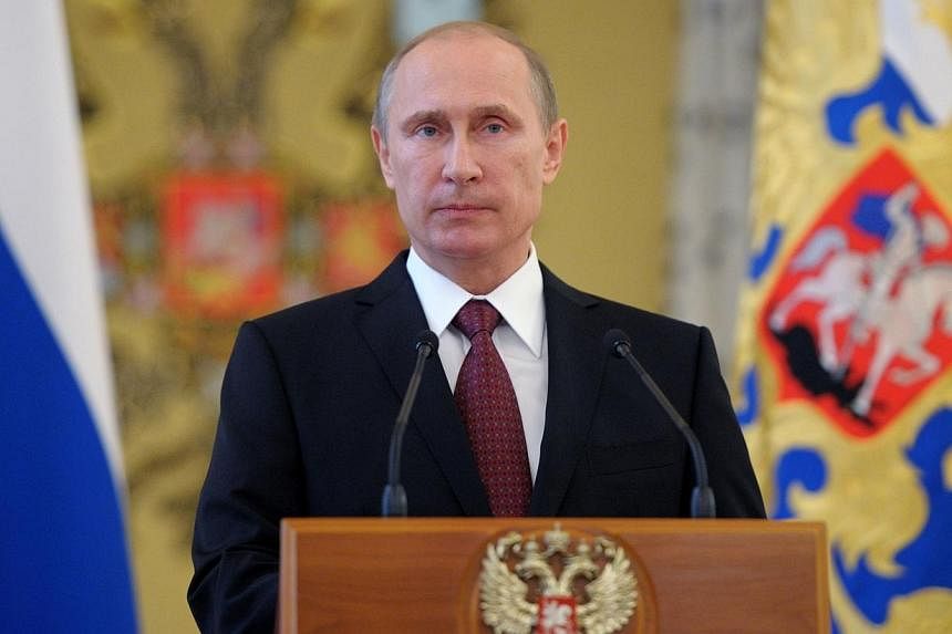 Russia's President Vladimir Putin attends a reception in honour of the military academies' graduates in the Kremlin in Moscow, on June 26, 2014. Mr Putin called on Friday, June 27, 2014, for a long-term ceasefire in Ukraine to allow for talks between