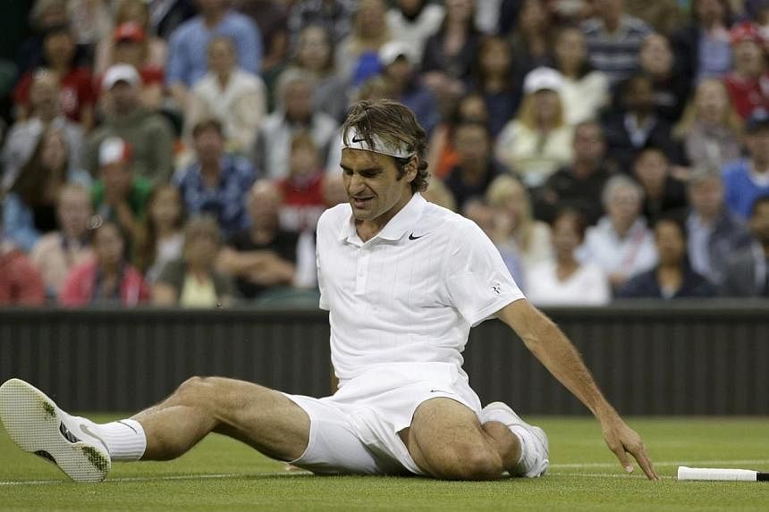 Roger Federer of Switzerland slips during their men's singles tennis match against Gilles Muller of Luxembourg on Centre Court at the Wimbledon Tennis Championships in London on June 26, 2014.&nbsp;Wimbledon's head groundsman Neil Stubley is relaxed 