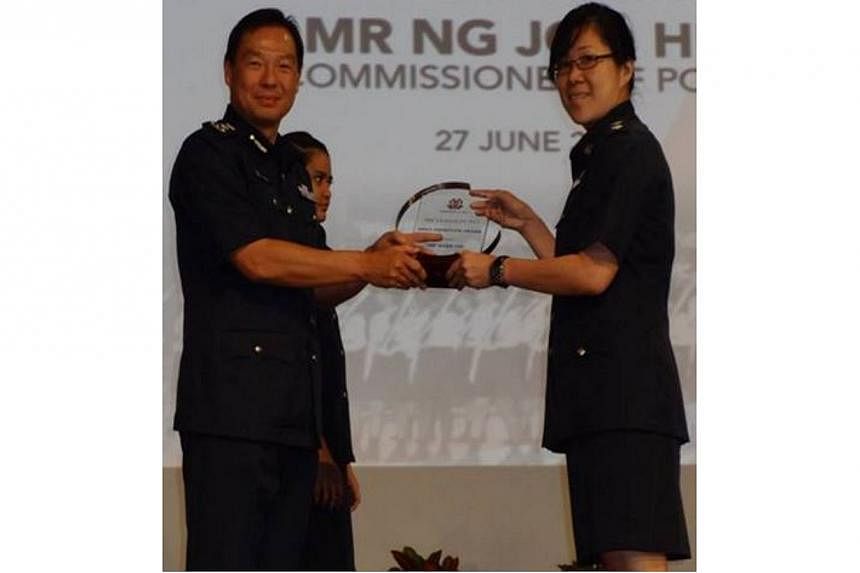 Deputy Superintendent of Police Tan Chin Yin (right) receiving the Most Improved Neighborhood Police Centre Award on behalf of Orchard Neighbourhood Police Centre. &nbsp;-- PHOTO: SINGAPORE POLICE FORCE