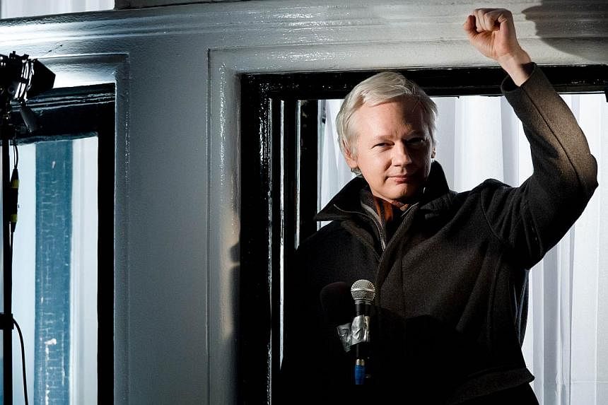 In this file picture taken on December 20, 2012 Wikileaks founder Julian Assange addresses members of the media and supporters from the window of the Ecuadorian embassy in Knightsbridge, west London. -- PHOTO: AFP