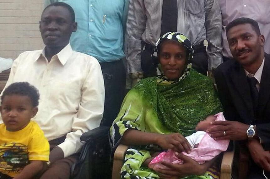 Ms Meriam Yahia Ibrahim Ishag posing for a smartphone photo at an undisclosed location with her husband Daniel Wani (left), her newborn baby, their 20-month-old son, lawyer Mohamad Mustafa (right) and other members of her legal team (cropped) on June