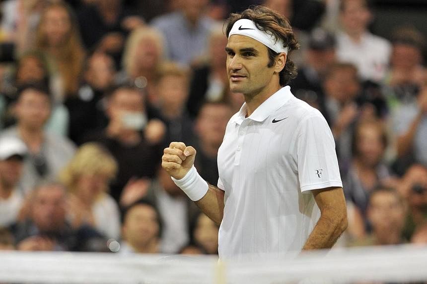 Switzerland's Roger Federer celebrates beating Luxembourg's Gilles Muller during their men's singles second round match on day four of the 2014 Wimbledon Championships at The All England Tennis Club in Wimbledon, southwest London, on June 26, 2014. -