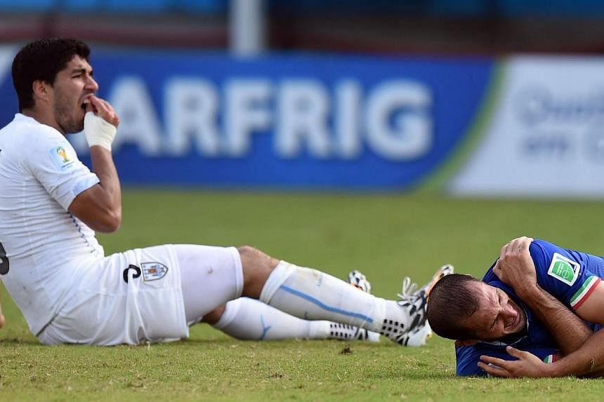Italy's Giorgio Chiellini (right) holding on to his shoulder after being allegedly bitten by Uruguay's Luis Suarez during their World Cup game on Tuesday. Football has had a violent history that included kickabouts with the heads of defeated enemies,