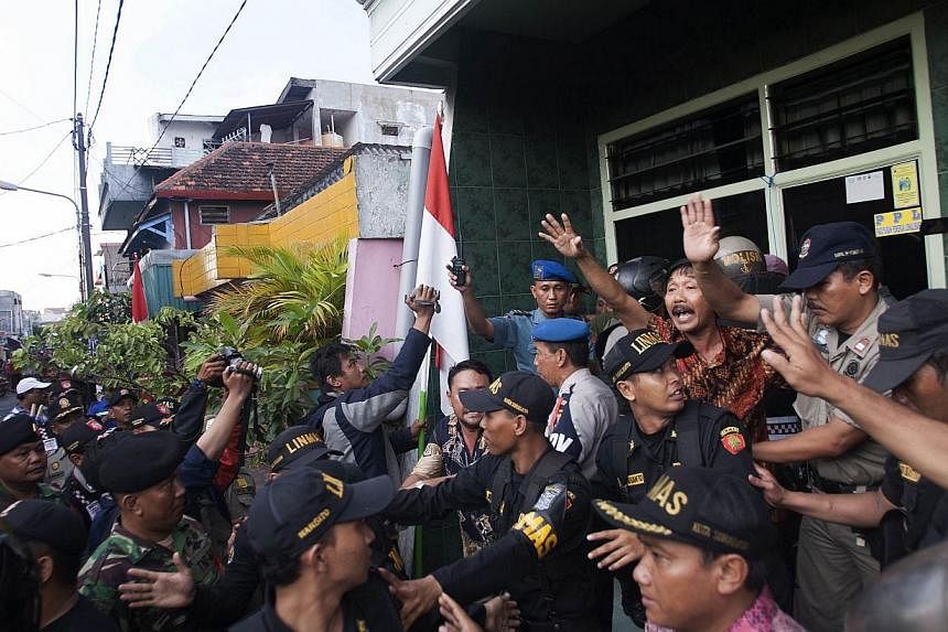 Indonesian police, civil security and army personnel conduct an operation in the red-light district, popularly known as 'Dolly', in preparation for the forthcoming Islamic holy month of Ramadan and to enforce a government closure order there in Surab