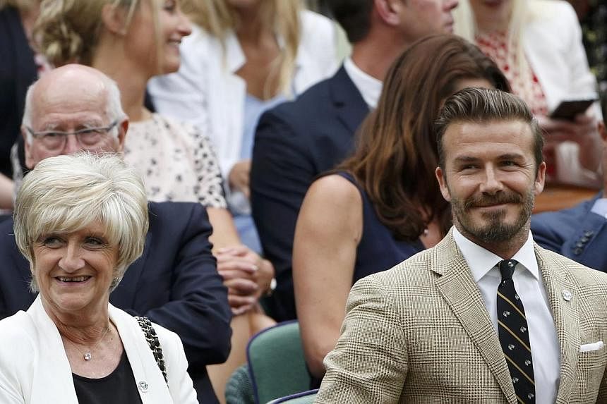 Former England soccer captain David Beckham (second right) sits with his mother Sandra (left) on Centre Court at the Wimbledon Tennis Championships, in London on June 28, 2014. -- PHOTO: REUTERS