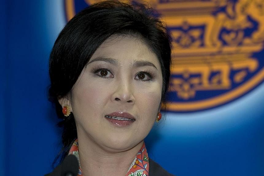 Thai Prime Minister Yingluck Shinawatra answers questions from the media during a press conference at the permanent secretary for defence suburb of Bangkok on May 7, 2014. -- PHOTO: AFP