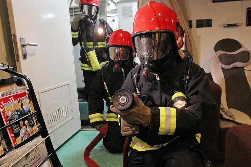 Crew of RSS Formidable undergo and fire damage control drill in a recreation room. The RSS Formidable has won Best Ship for the second time in the SAF Day Best Unit Competition.&nbsp;-- ST PHOTO: SEAH KWANG PENG