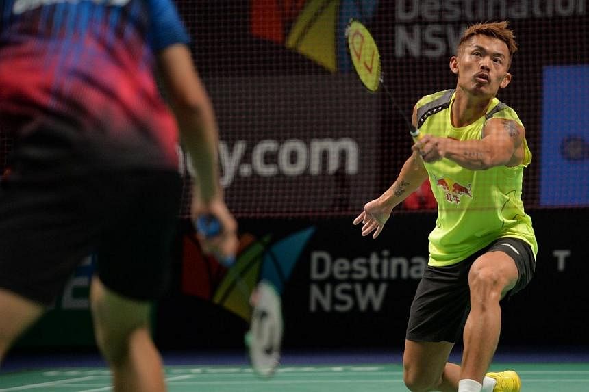 Lin Dan of China (right) hits a return to Simon Santosa of Indonesia (left) in the men's singles final at the Australia Open badminton tournament in Sydney on June 29, 2014. Lin Dan won the match 22-24 21-16 21-7.&nbsp;Chinese superstar Lin Dan fough
