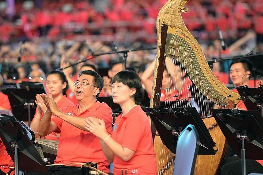 A mass of musicians playing in the new Sports Hub on Saturday, June 28, 2014. -- ST PHOTO: DESMOND WEE&nbsp;