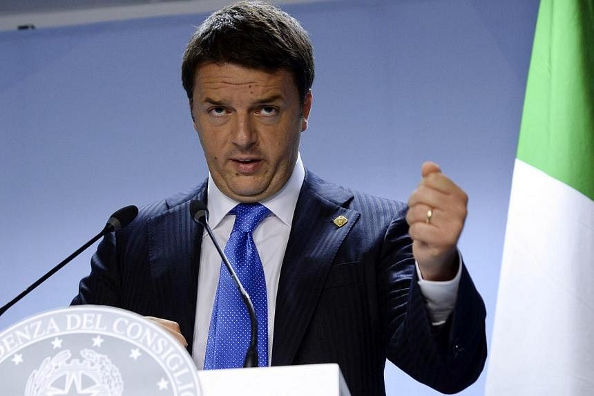 Italy's Prime Minister Matteo Renzi talks to the media at the end of an EU Summit held at the EU Council building in Brussels, on June 27, 2014. -- PHOTO: AFP&nbsp;
